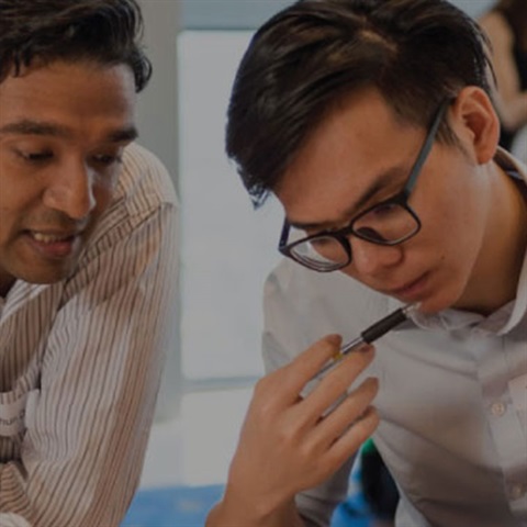 Two men looking at desk