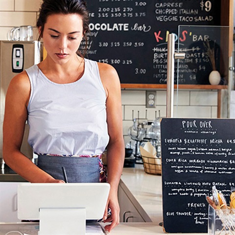 Woman behind register at cafe