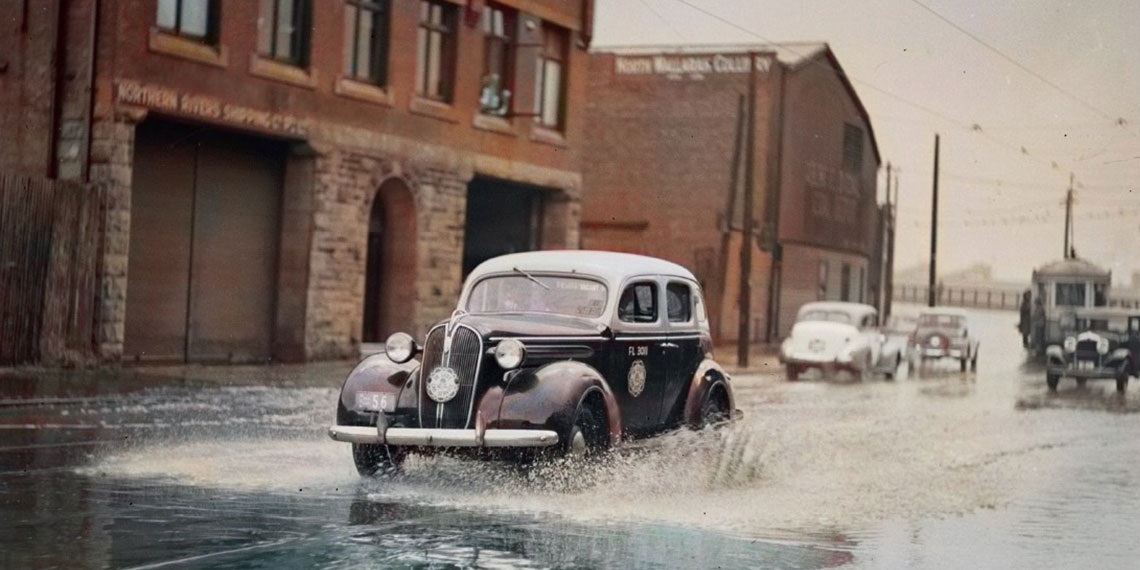 Vintage car driving through floodwater