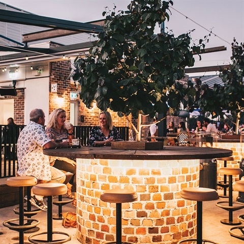 People sitting around table at bar