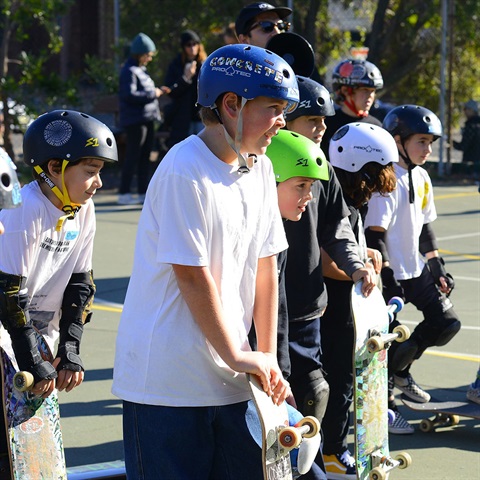 Kids on scooters and skateboards
