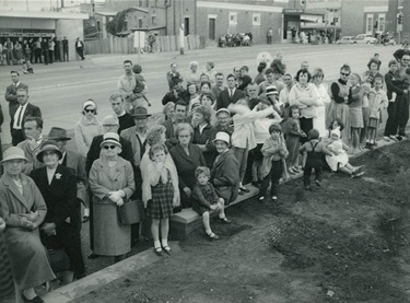 Section of the crowd at the official opening of Ryde Civic Centre. The administration building of the Ryde Civic Centre was unveiled on 15 August 1964. Here the crowd is looking up at the new modern building based on the design of the AMP building at Circular Quay. Ryde Library Service. Acc. 5089557. Ryde Civic Centre / 6