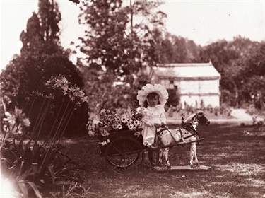 Hazel Lois Linsley born 1902 with her toy horse and cart full of flowers. She was the daughter of William Hessell and Annie Linsley. The Linsleys lived at Ermington Park.  Ryde District Historical Society. Image 4307; negative 170/9a.