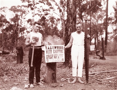 Wood chopping, Eastwood.  Les McIntosh & Jock McCarthy holding notice of competition to be held on vacant land at rear of Eastwood Hotel, Rowe Street, Eastwood, May 1921.  Ryde District Historical Society. Image 6205; negative 238/8.