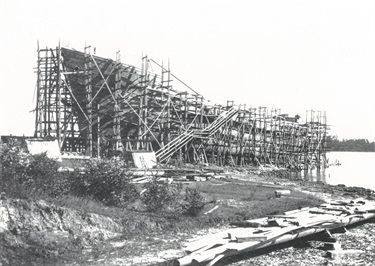 Wooden ship under construction at Kissing Point, Kidman & Mayoh Shipyard around 1919. Kidman & Mayoh were contracted to six build wooden ships, as steel was extremely difficult to obtain during WWI. The hulls were to be of Australian hardwood and the masts and spars of oregon. In the end only two were built, the Braeside and the Burnside, though neither of them was seaworthy. Ryde Library Service. Acc. 4783026. Kidman & Mayoh Shipyard / 18.
