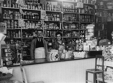 Les & Hilda Hartley inside Hartley’s general store, 59 Ryedale Road, West Ryde around 1940. The earliest shopping strip in West Ryde developed in Ryedale Road, on the eastern side of the railway line. The station was originally called Ryde Station. Ryde Library Service. Acc. 5482364. West Ryde / 4.