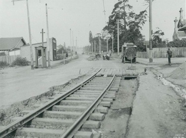 Looking east along Victoria Road at intersection of Bowden Street, 23 July 1930; workmen relocating tram track prior to reconstruction of Victoria Road. Not only was work being done on Victoria Road, but around this time it received the name Victoria Road. Before this date, the road west of St Anne’s Church was called Parramatta Road and Monash Road at Gladesville was called Victoria Road. The building on the right hand side is the mansion Lauriston, demolished 1959 and replaced with the Metro Motor Inn. Ryde Library Service. Acc. 5578264. Victoria Road, Ryde / 4.