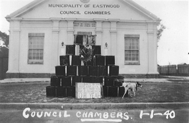 Protest over compulsory sanitary service outside the Eastwood Town Hall, 1 January 1940. Prior to 1940 most residents of Marsfield and North Ryde buried their own nightsoil on their poultry farms and orchards. By 1939 Eastwood (formerly Marsfield) Council decided to extend its nightsoil collection service to every residence in the municipality. The new arrangements were to come into force on 1 January 1940 but many residents with large blocks of land could see no reason to pay for a service that they could still carry out quite satisfactorily for themselves. When the first pan was delivered they returned it to the front of the town hall. The dog’s action appears to be summing up the residents’ thoughts! Ryde Library Service. Acc. 5579295. Eastwood Town Hall / 1.