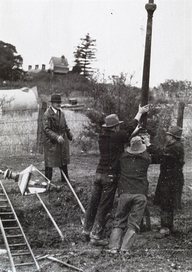 Coxs Road, North Ryde: last gas lamp being dismantled in Sydney. An unemployment relief project involved the extension of street lighting to large parts of North Ryde in late 1934. The newly defunct gas lamp in this photograph in the process of being dismantled was in Coxs Road, near the intersection with Lane Cove Road. The house Pomona can be seen in the background. Ryde District Historical Society. Image 3728; negative 152/8.