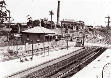 Ryde Pumping Station; southern end of Ryde Railway Station. This photograph shows the original pumping station and the southern end of Ryde Railway Station. Before the underpass was built which allowed Victoria Road to travel underneath the railway line, the intersection of the railway line and the road was controlled by a level crossing. Ryde District Historical Society. Image 6335; negative 242/6a.