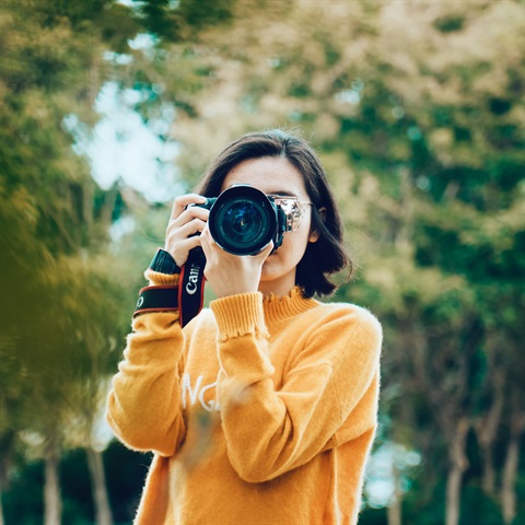 Photo of a person holding a camera