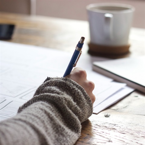 Photo of a person writing