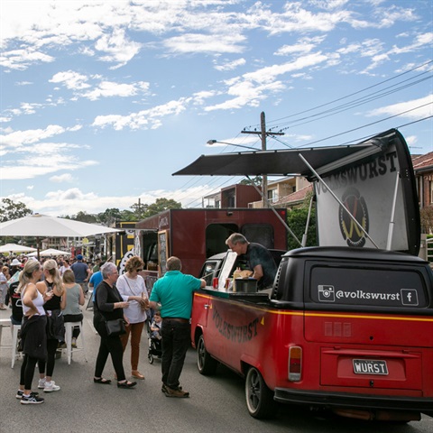 Food trucks and crowd of people in street