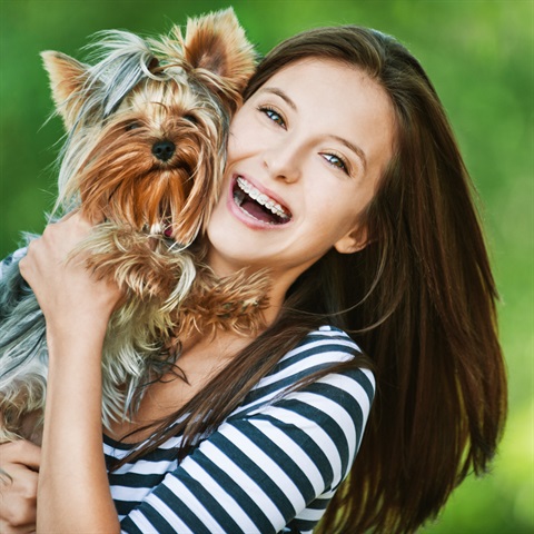 Smiling woman holding her dog
