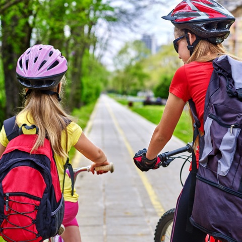 Two people riding bicycles on cycle path