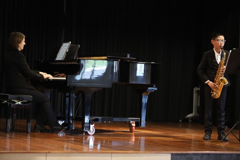 pianist and saxophonist performing on stage together