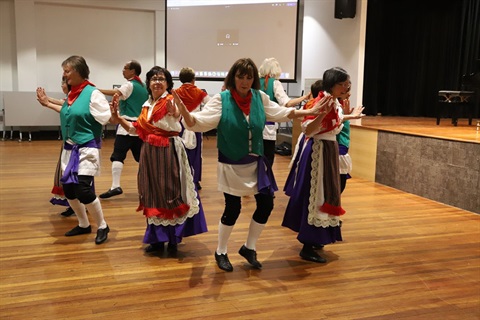 Senior ladies in folk costumes dancing