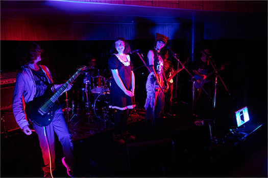 A band of musicians play on stage
