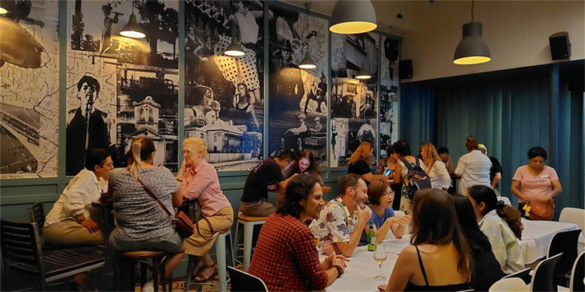 People at tables, talking