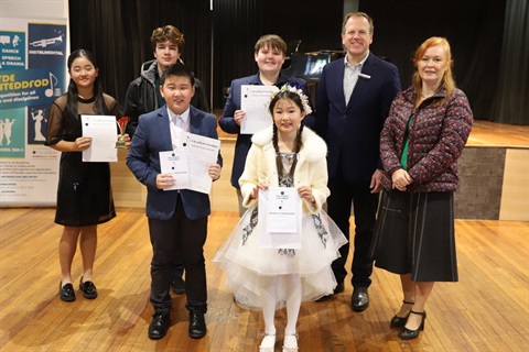 Group of young performers posing with certificates next to Mayor and instructor