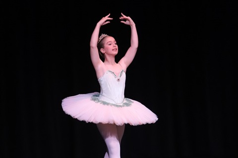 Young girl doing a ballet performance on stage