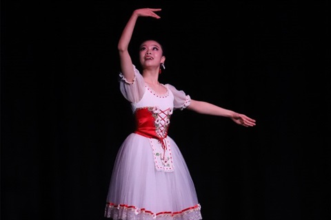 Girl in red and white dress dancing on stage