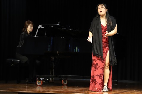Singer and pianist performing on stage