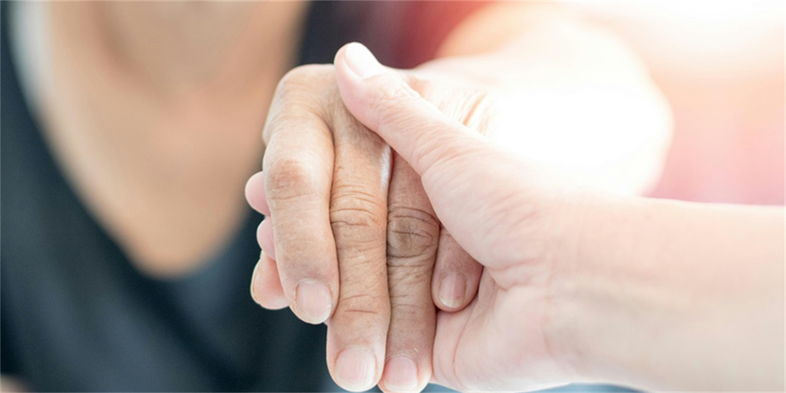 View of a person holding onto someone's hand