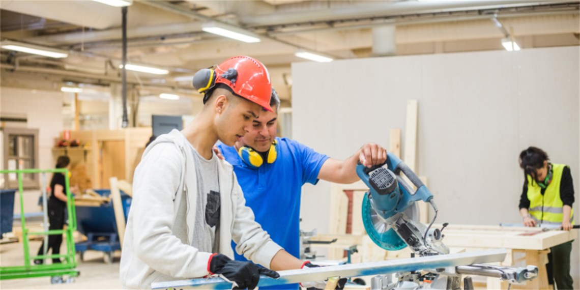 Instructor teaches student how to work with a circular saw