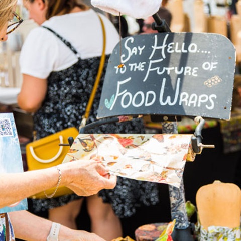 Woman holding beeswax wrap at market