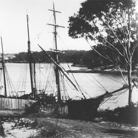 An old boat docked by a wharf