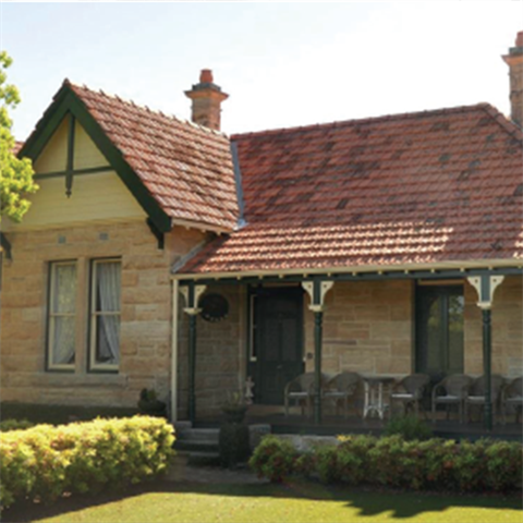 A single storey home with neatly trimmed lawn and shrubs