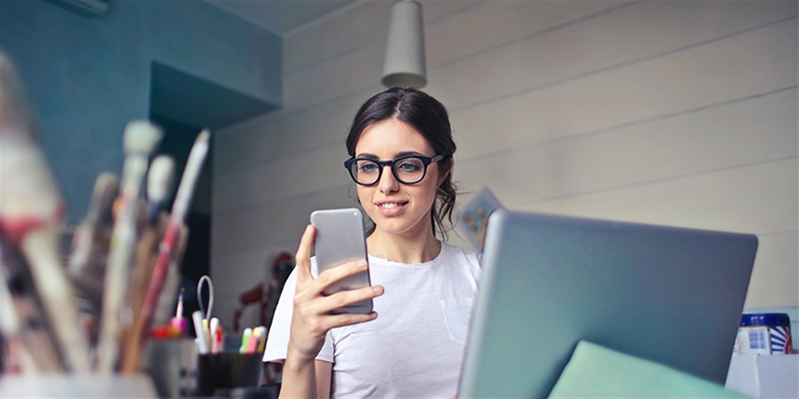 A photo of a person holding a mobile device