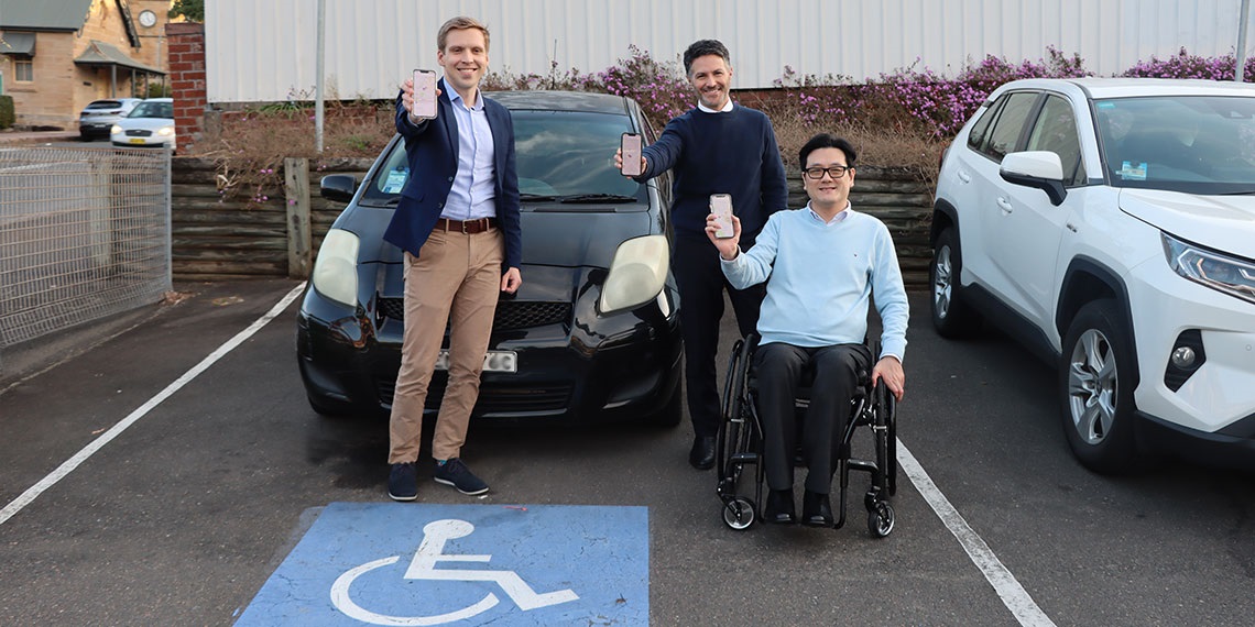 Mayor, Minister Dominello and Eddie Tsang outside accessible parking spot