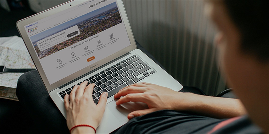 Person on laptop using Grant Finder