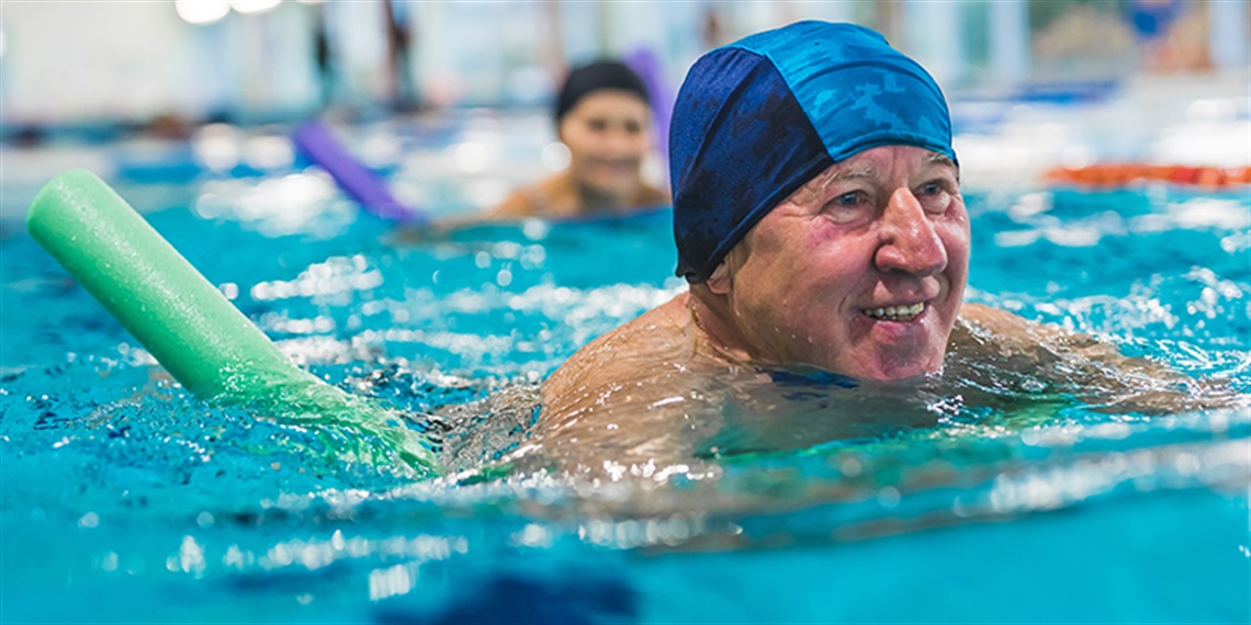 Senior gentleman swimming in pool