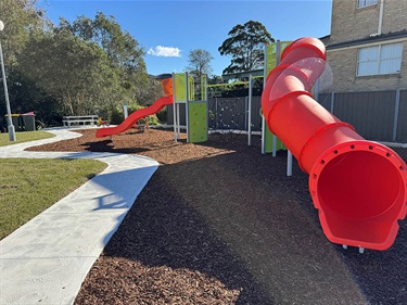 Red slides and paved pathway