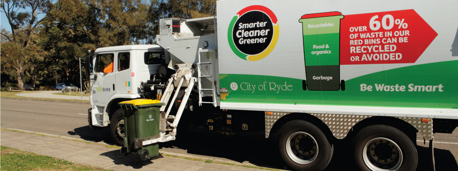 Recycling bin being collected by truck
