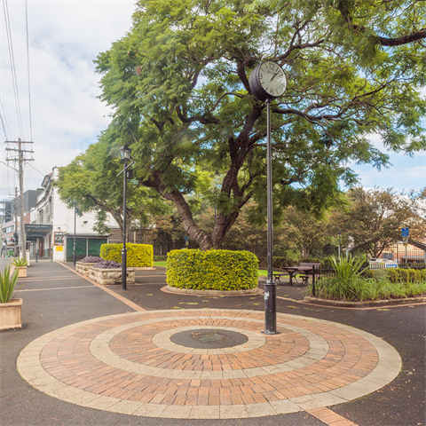 View of Trim Place, outdoor park area with clock on a pole