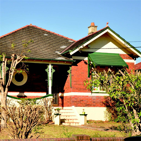 Single storey house amongst trees and shrubs
