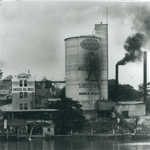 An industrial building sitting by the water