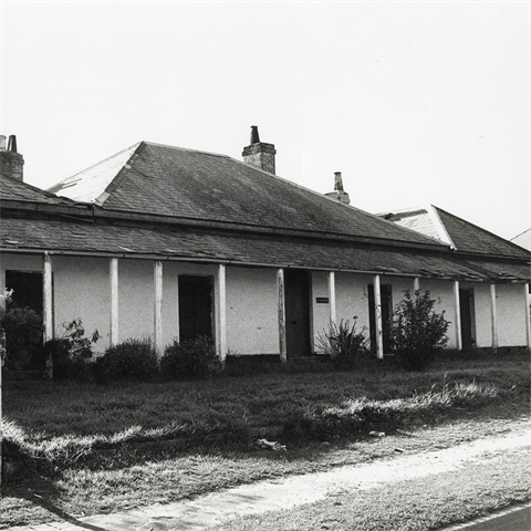 View of a single storey house, called Addington House, with a front lawn. 